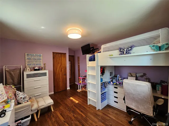 a work room with furniture and wooden floor