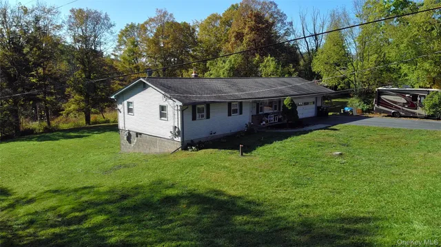 a view of a house with a garden and yard