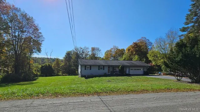 a front view of a house with a yard and an outdoor space