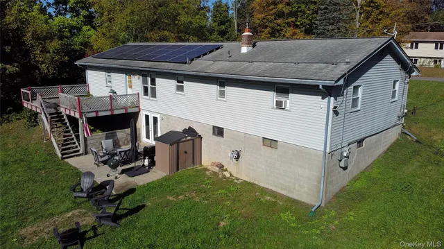 a view of a white house and a yard in the back
