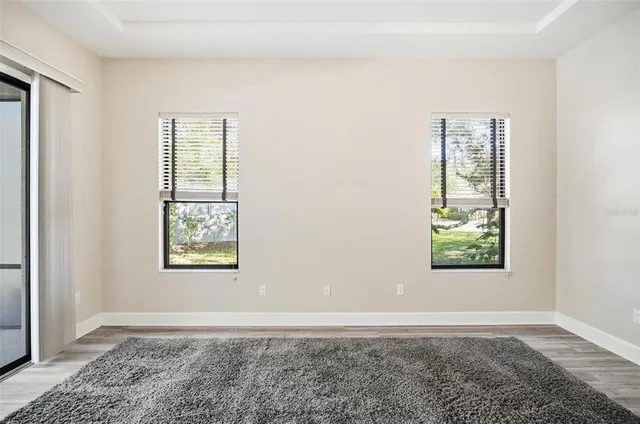 a view of an empty room and chandelier fan