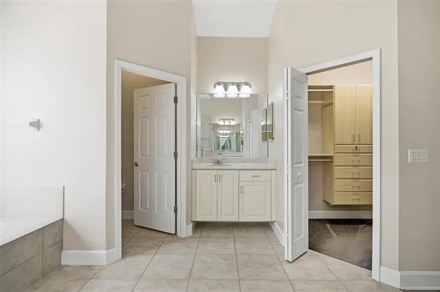 a view of a hallway with wooden floor and entryway