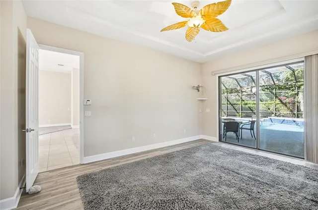 an aerial view of residential houses with outdoor space and trees
