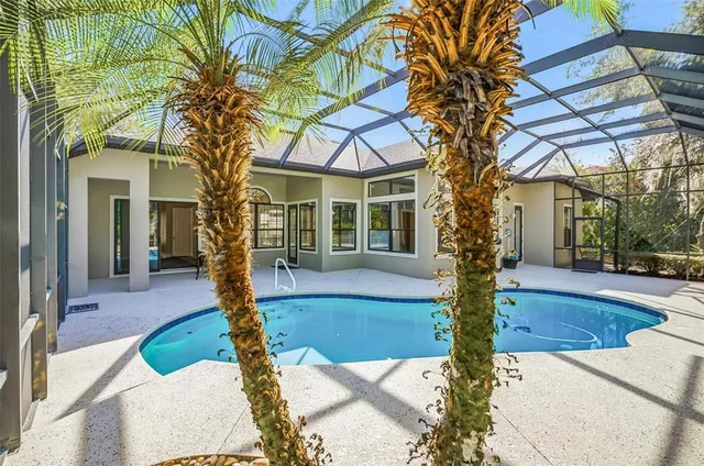 an empty room with windows fireplace and cabinet