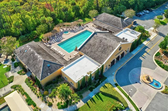 an aerial view of residential houses with outdoor space and ocean view