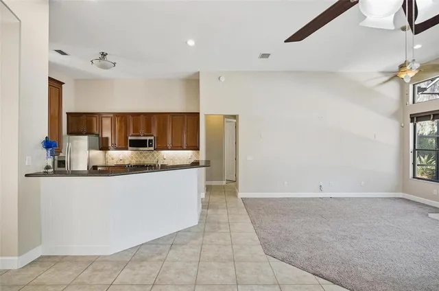 a view of hallway with window and wooden floor