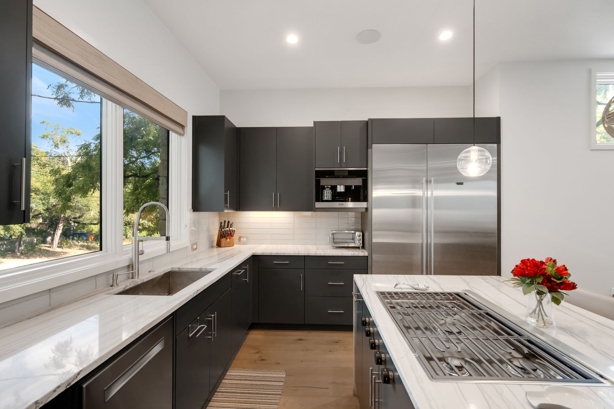 809 Bouldin Avenue Austin, TX 78704 - Photo 4 of 39 a kitchen with stainless steel appliances granite countertop a sink stove and refrigerator