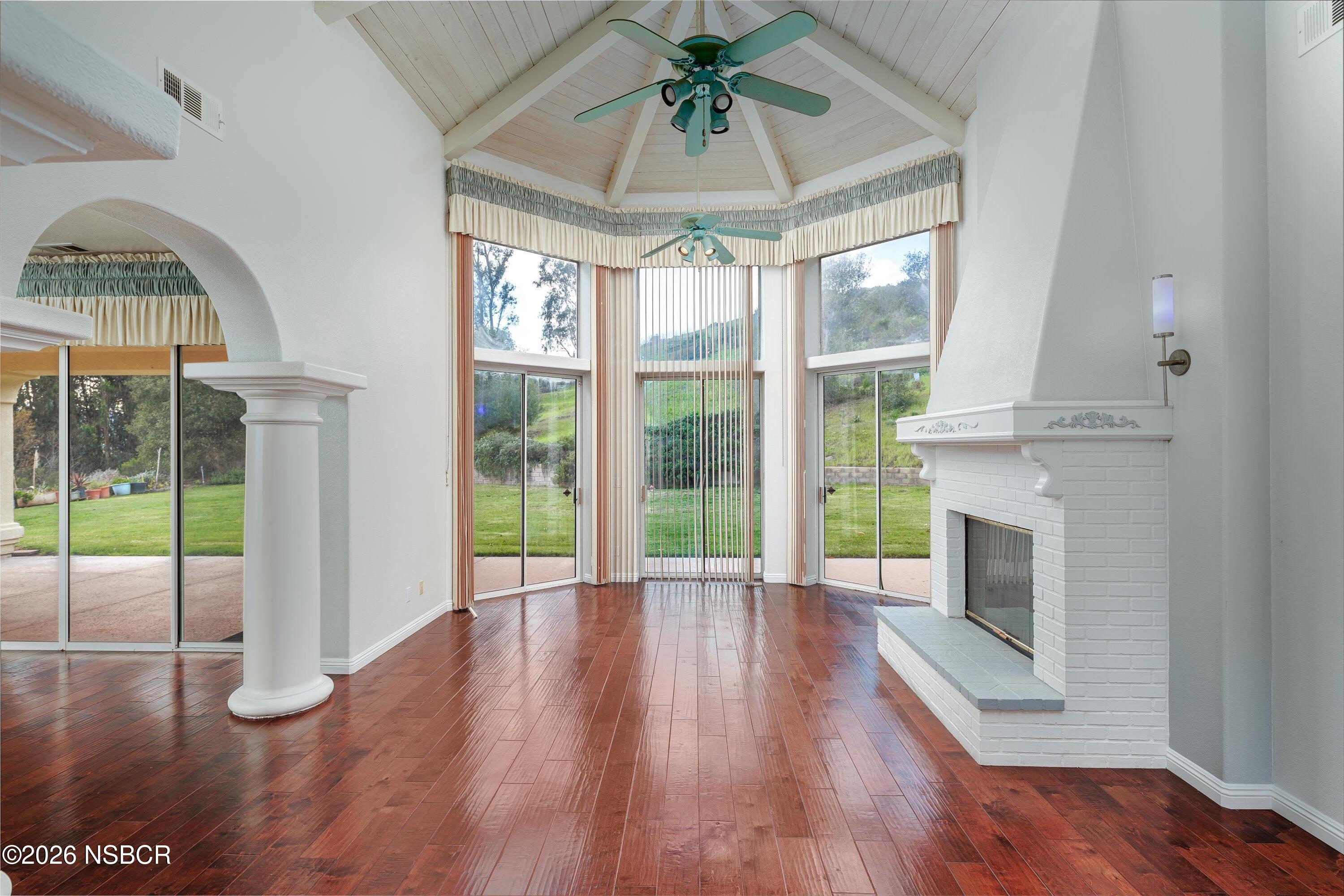 2655 Adobe Falls Road Lompoc, CA 93436 - Photo 12 of 51 a view of an empty room with wooden floor and a fireplace