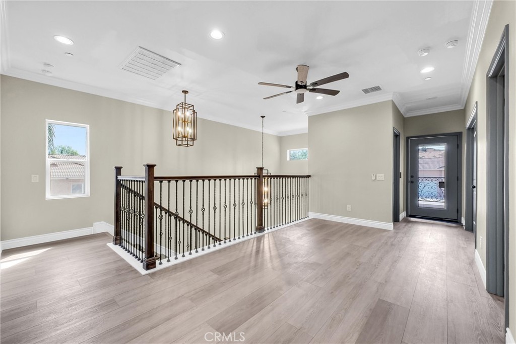 14388 Dove Canyon Drive Riverside, CA 92503 - Photo 15 of 38 a view of a hallway with wooden floor and windows