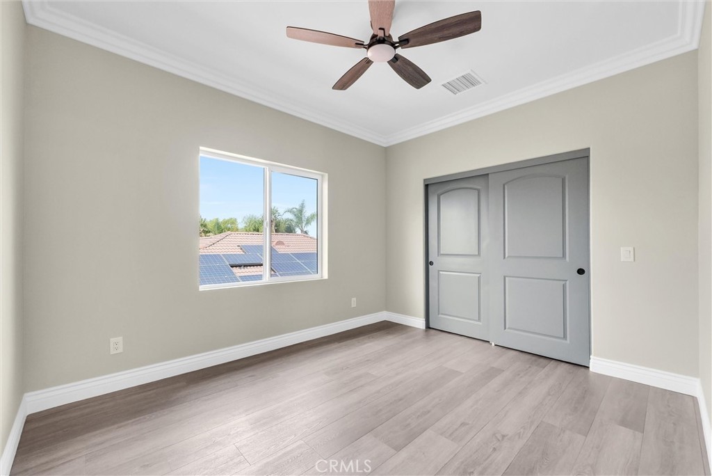 14388 Dove Canyon Drive Riverside, CA 92503 - Photo 18 of 38 a view of empty room with wooden floor and fan