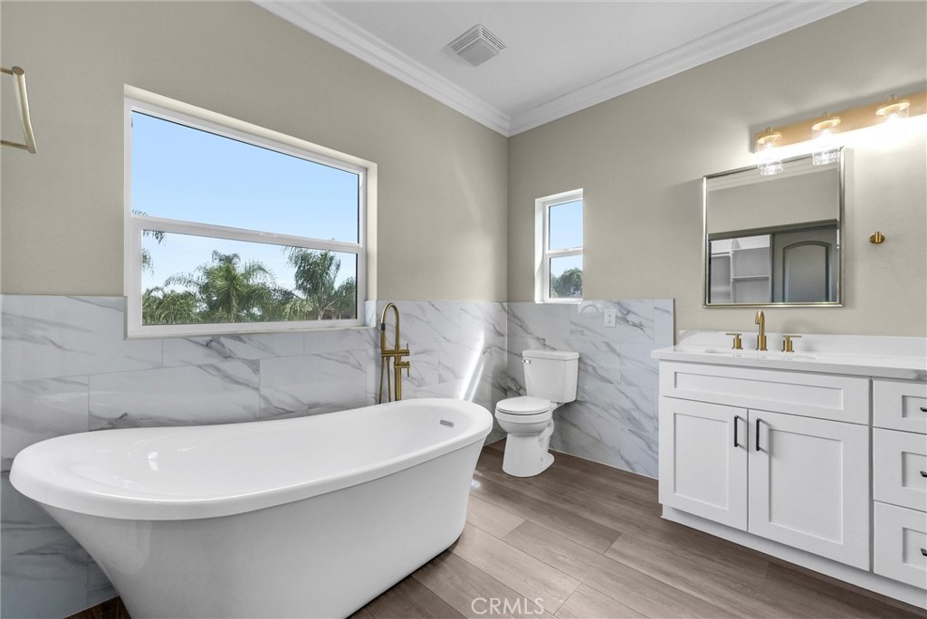 14388 Dove Canyon Drive Riverside, CA 92503 - Photo 27 of 38 a white bath tub sitting next to a white toilet