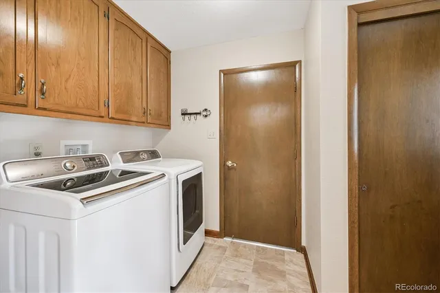 a view of a utility room with closet and windows