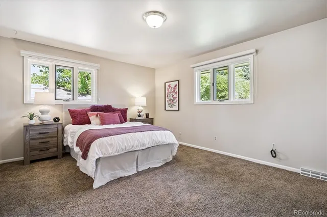 a spacious bedroom with a bed and a view of bathroom