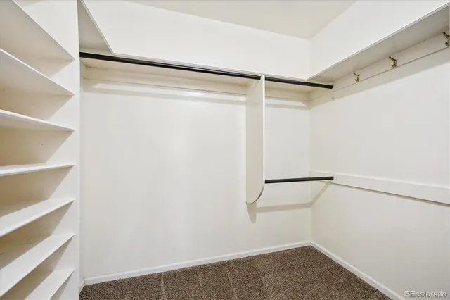 a bedroom with a bed and a lamp