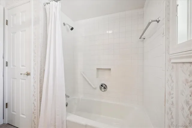 a bedroom with a bed and windows