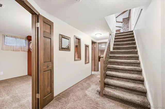 a spacious bedroom with a bed and a couch