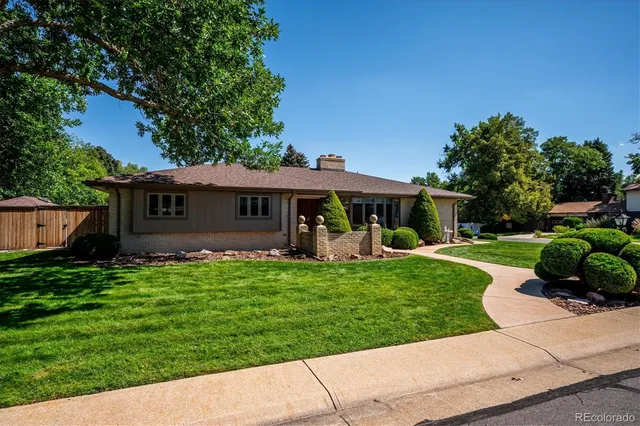 a front view of a house with a yard table and chairs