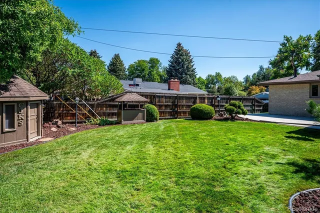 a front view of a house with a yard and potted plants