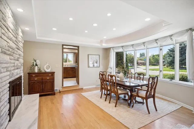 a dining room with furniture and wooden floor