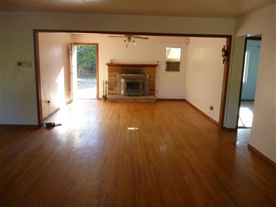 528 South Rice Road Ojai, CA 93023 - Photo 5 of 15 an empty room with wooden floor and fireplace