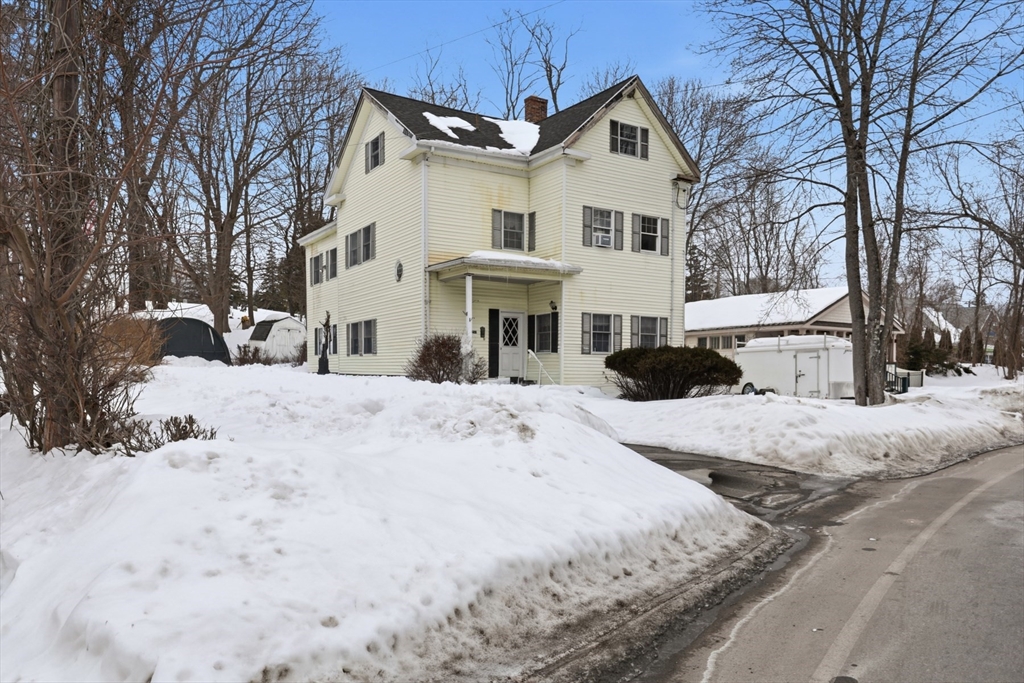 253 Main Street Amesbury, MA 01913 - Photo 1 of 10 a view of a white house with a snow on the road