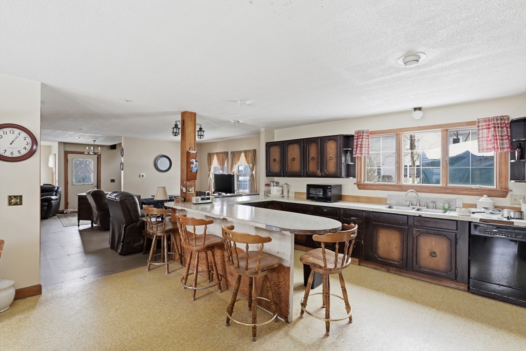253 Main Street Amesbury, MA 01913 - Photo 3 of 10 a large kitchen with a table and chairs