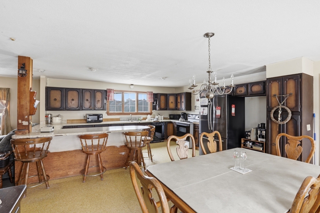 253 Main Street Amesbury, MA 01913 - Photo 4 of 10 a kitchen with a table and chairs in it