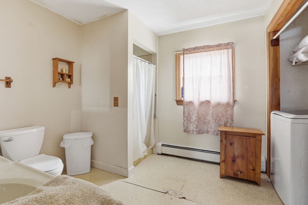 253 Main Street Amesbury, MA 01913 - Photo 6 of 10 a bathroom with a toilet and a shower
