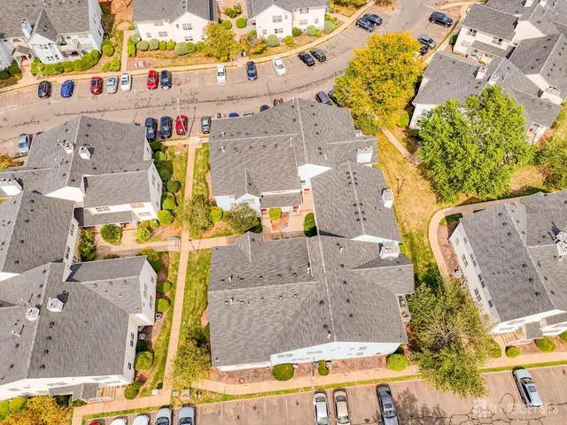an aerial view of residential houses with outdoor space