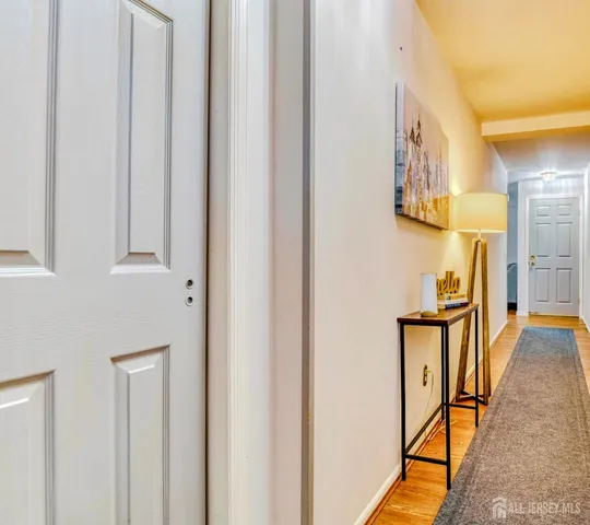 a view of a hallway with furniture