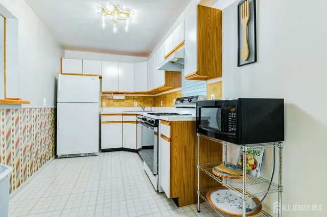 a kitchen with a sink appliances and cabinets