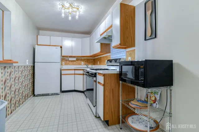 a kitchen with a sink appliances and cabinets