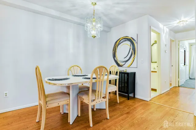 a dining room with furniture and chandelier