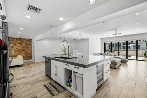 a large white kitchen with a stove and a sink