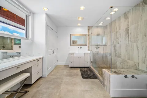 a bathroom with a tub a sink and a shower