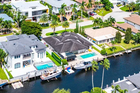 an aerial view of a house with swimming pool and outdoor seating