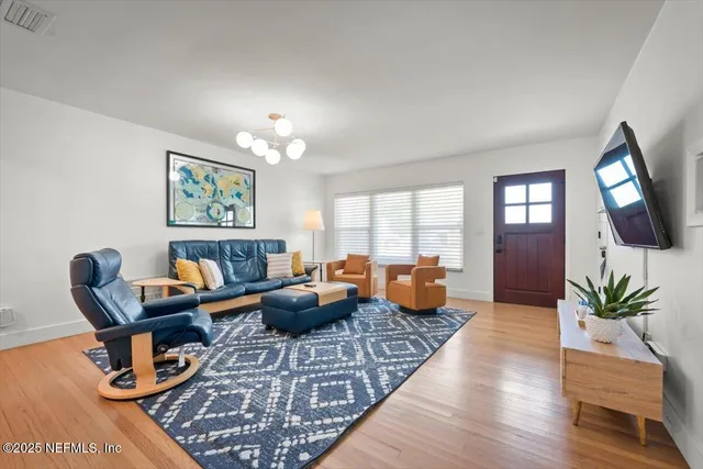 a view of cabinets a sink and a stove in a room