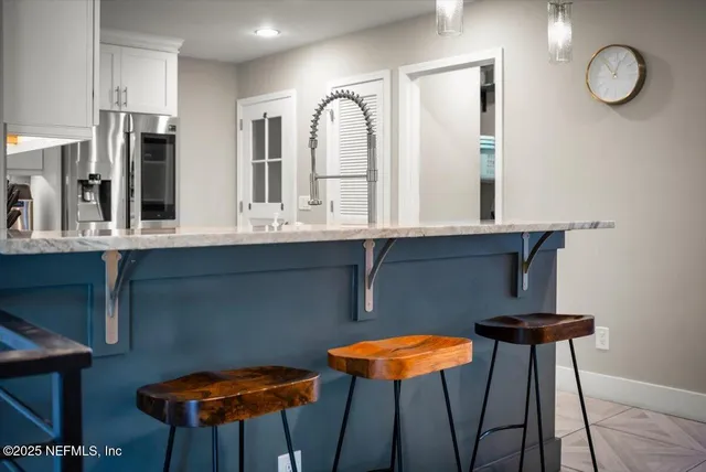 a kitchen with granite countertop a sink stainless steel appliances and cabinets