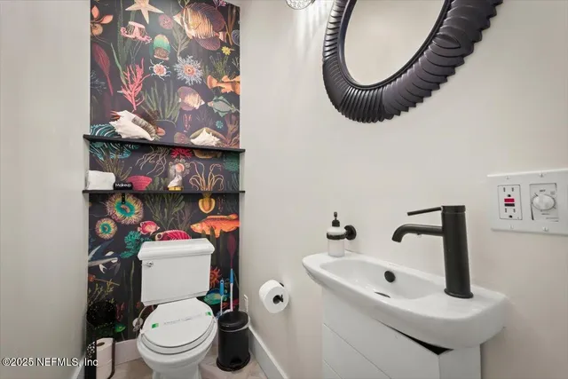 a living room with furniture a fireplace and wooden floor