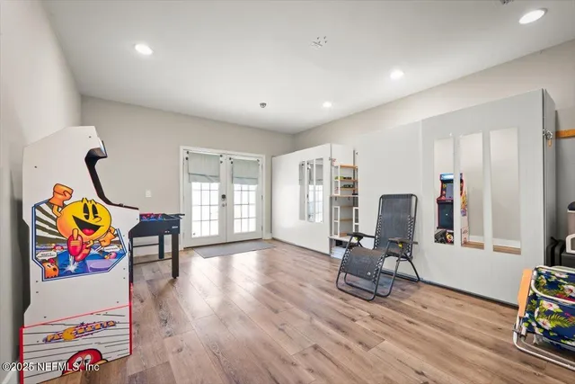 a living room with furniture a mirror and lamp