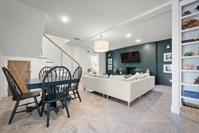 a white bed sitting in a room next to a window