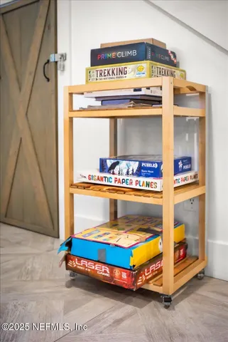 a dining room with furniture a chandelier and wooden floor