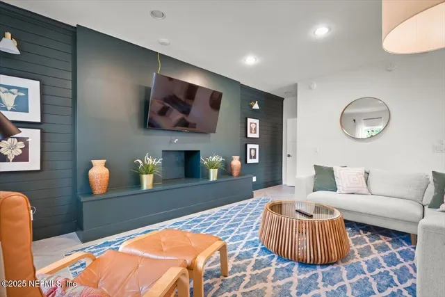 a spacious bedroom with a bed and a flat screen tv