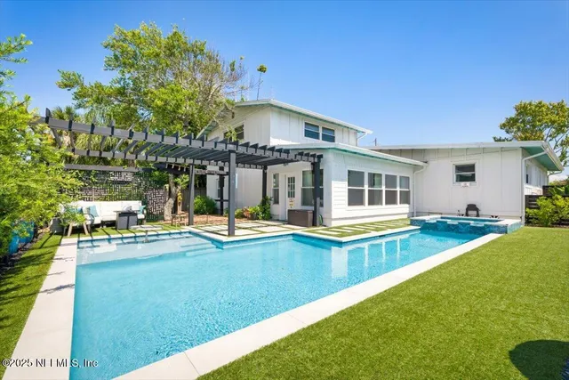 a bed sitting in a bedroom with a lamp