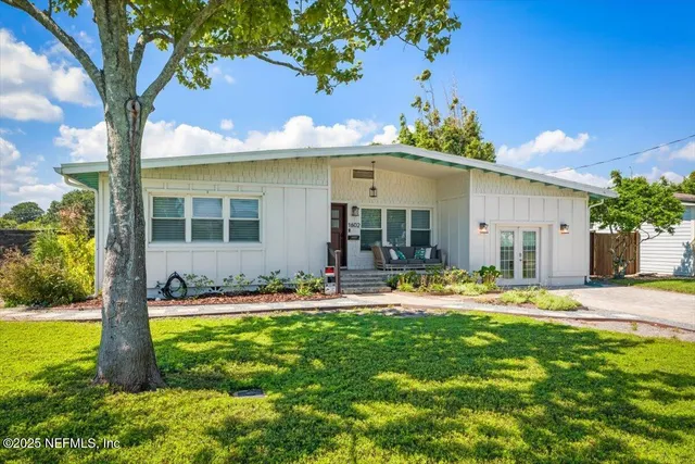 a view of a backyard with plants and a patio