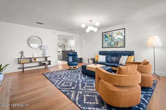a living room with furniture fireplace and wooden floor