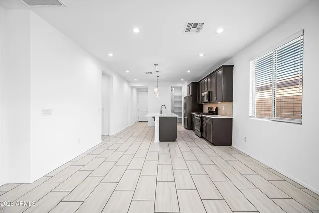 a kitchen with stainless steel appliances granite countertop a stove a sink dishwasher and a refrigerator