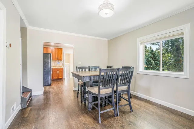 a view of a dining room with furniture and wooden floor