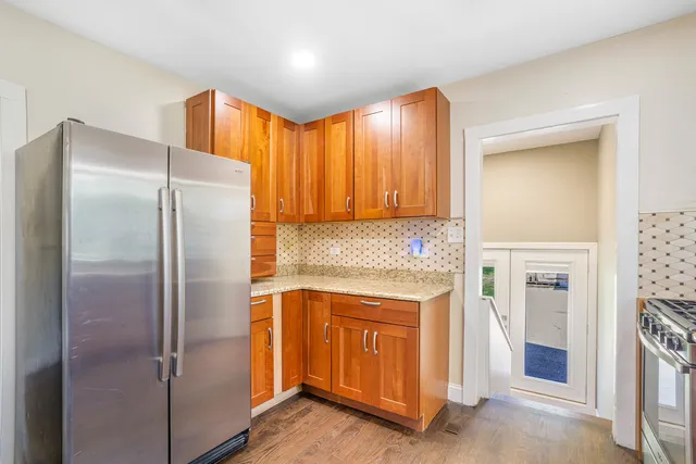 a kitchen with a refrigerator a sink and cabinets