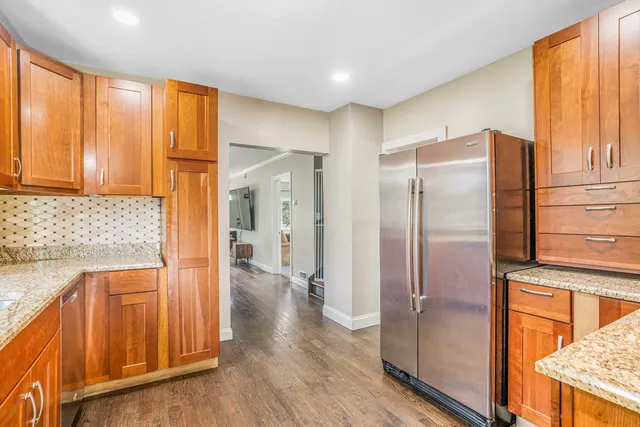 a kitchen with stainless steel appliances granite countertop a refrigerator and a sink
